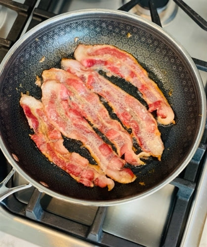 Frieling Black Cube Fry Pan with bacon sizzling