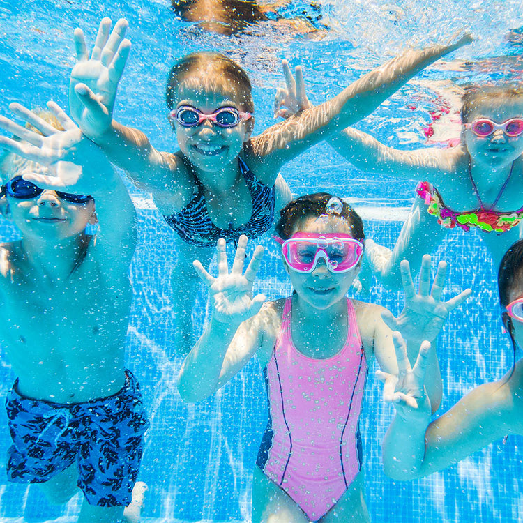Children swimming in crystal clear water