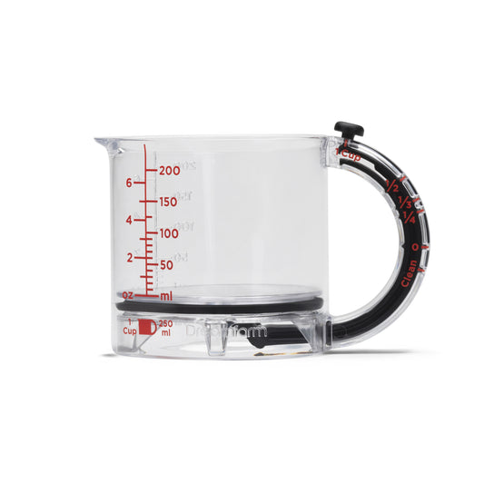 Clear measuring cup with black handle and red measurement markings on a white background