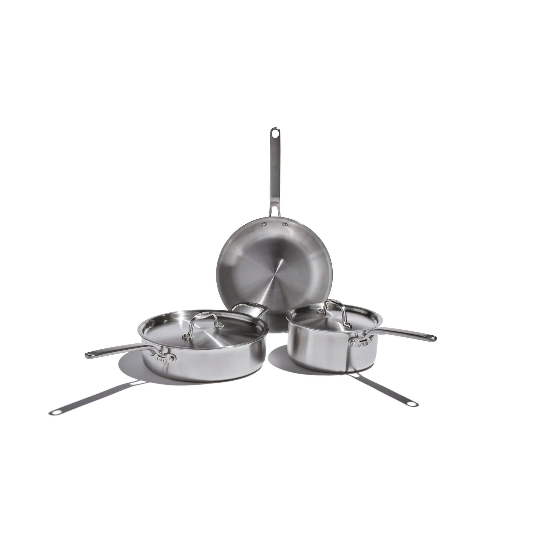 Set of stainless steel cookware on a white background