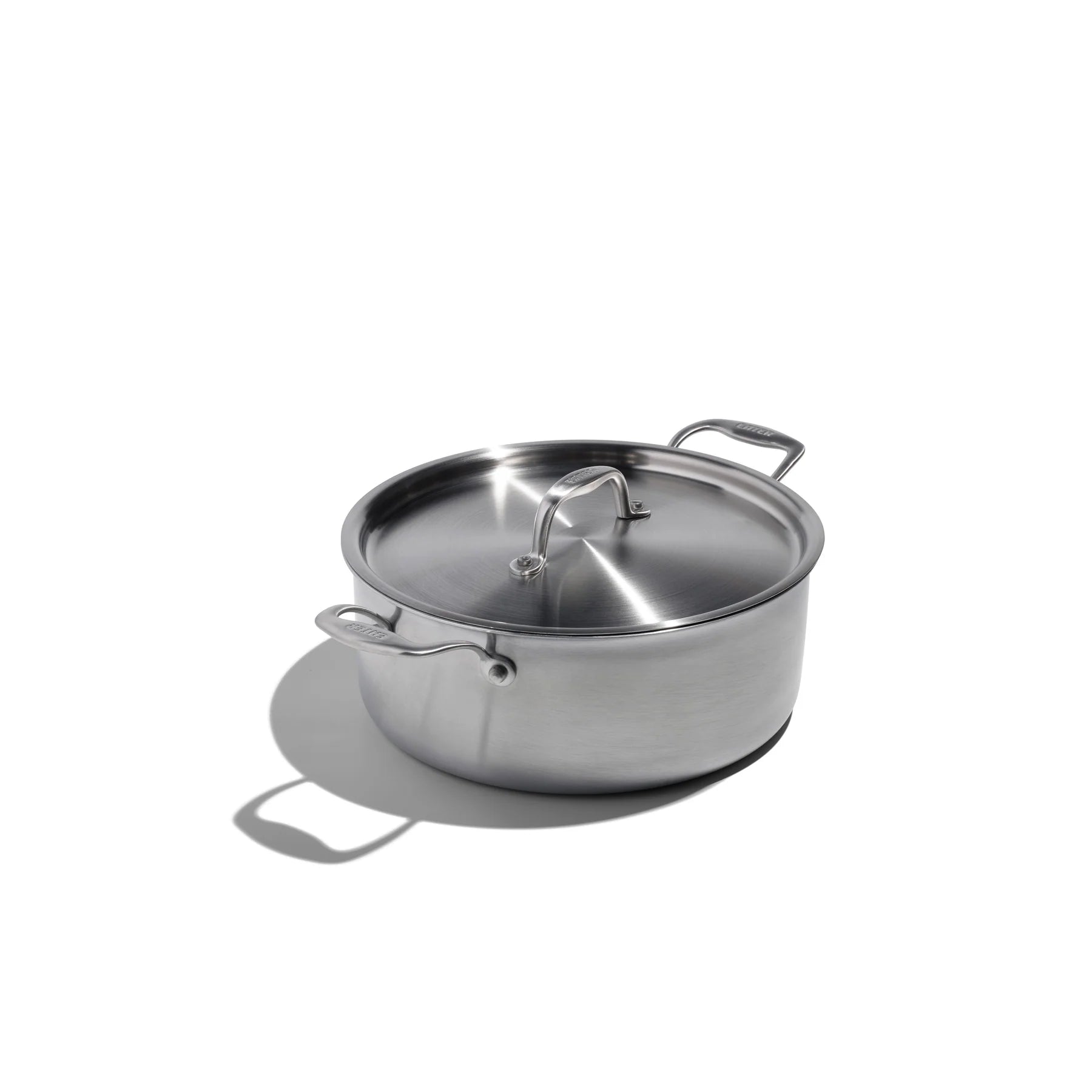 Stainless steel pot with lid on a white background