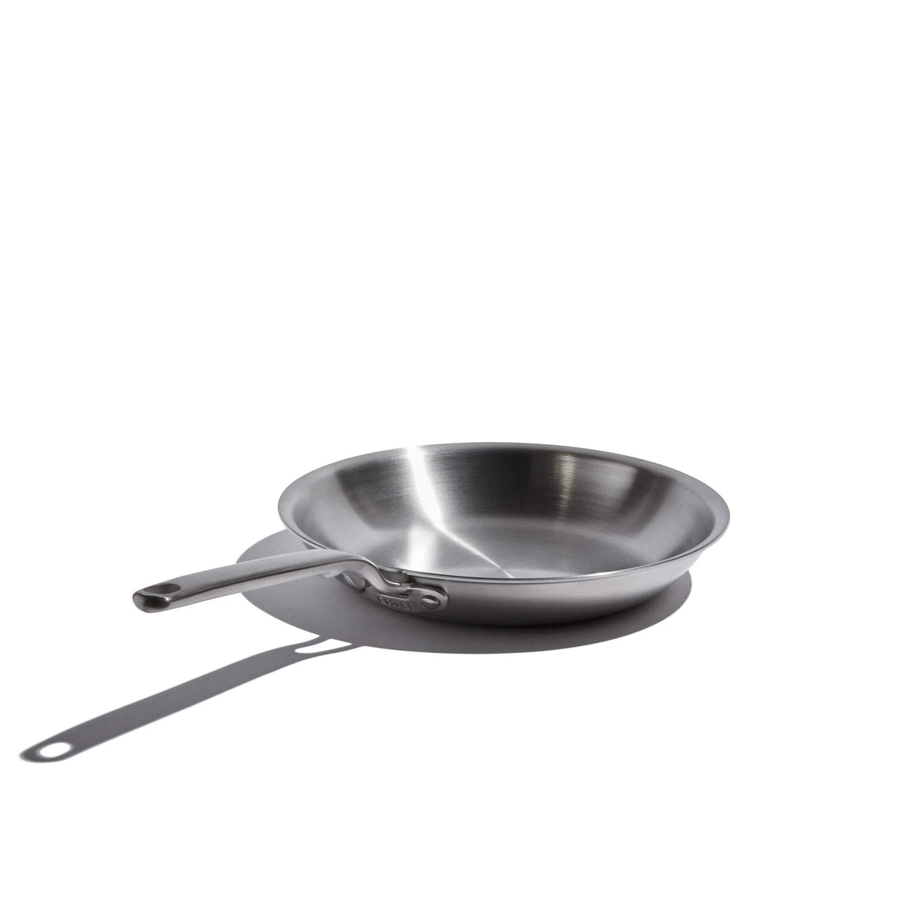 Stainless steel frying pan on a white background