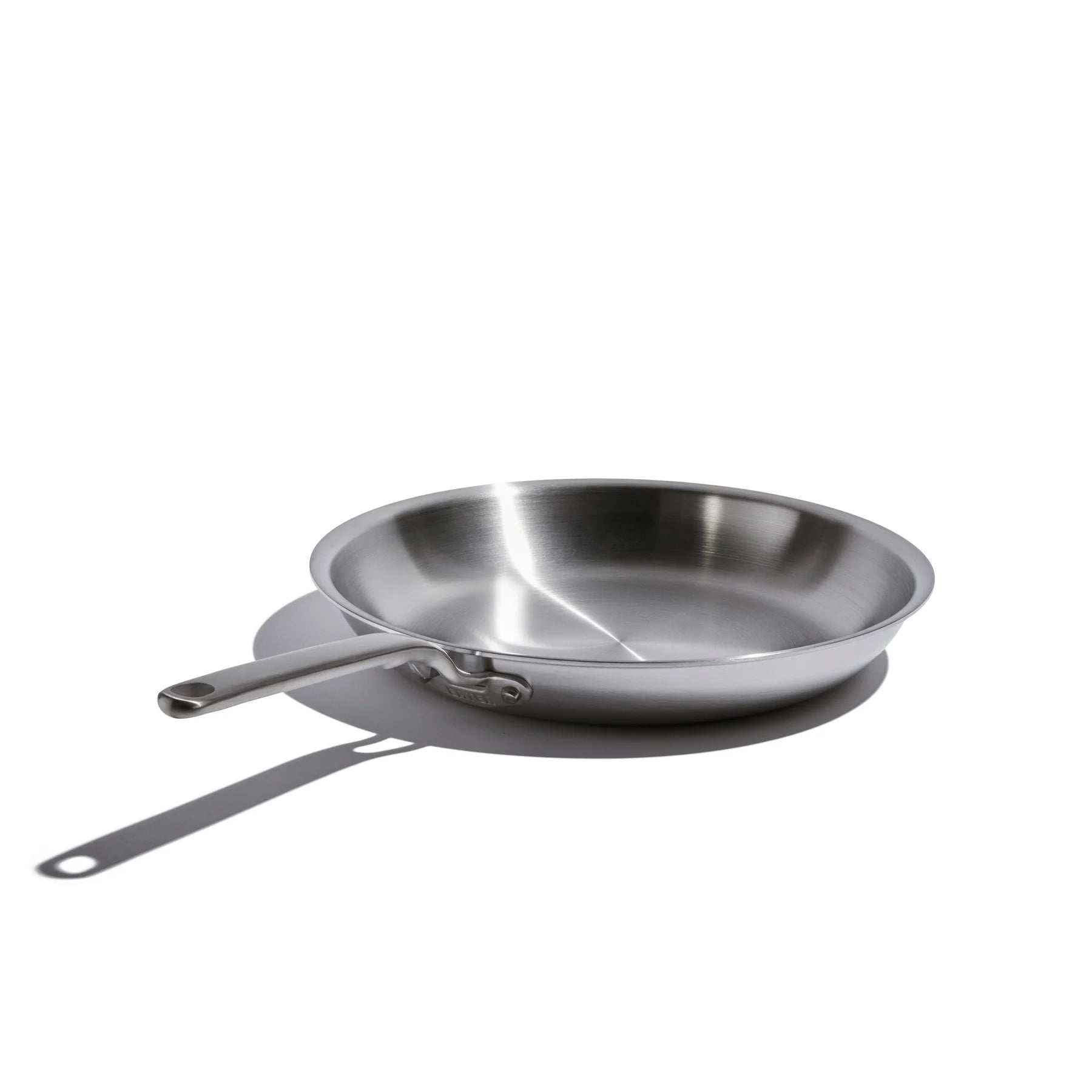 Stainless steel frying pan on a white background