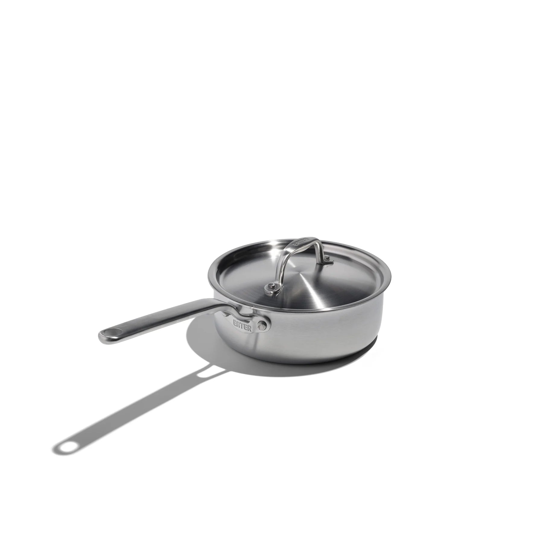 Stainless steel saucepan with lid on a white background
