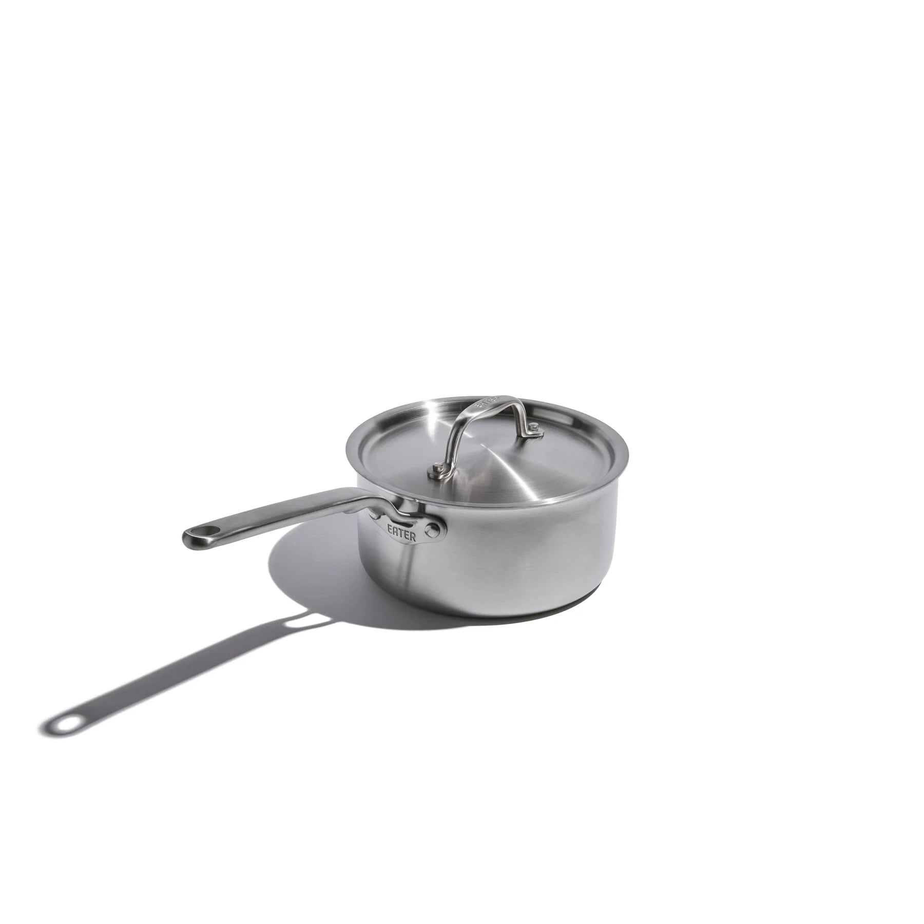 Stainless steel saucepan with lid on a white background
