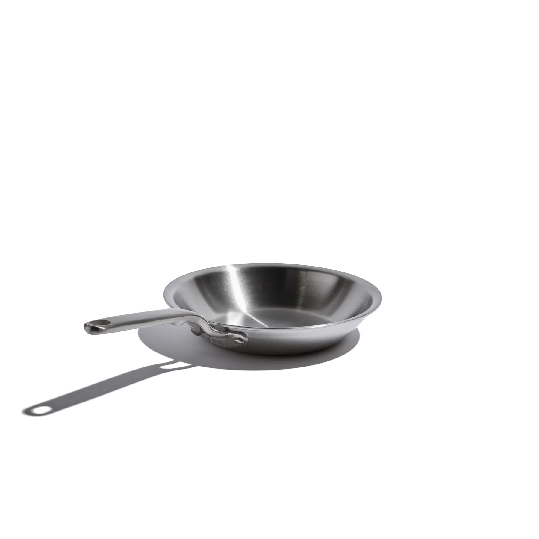 Stainless steel frying pan on a white background
