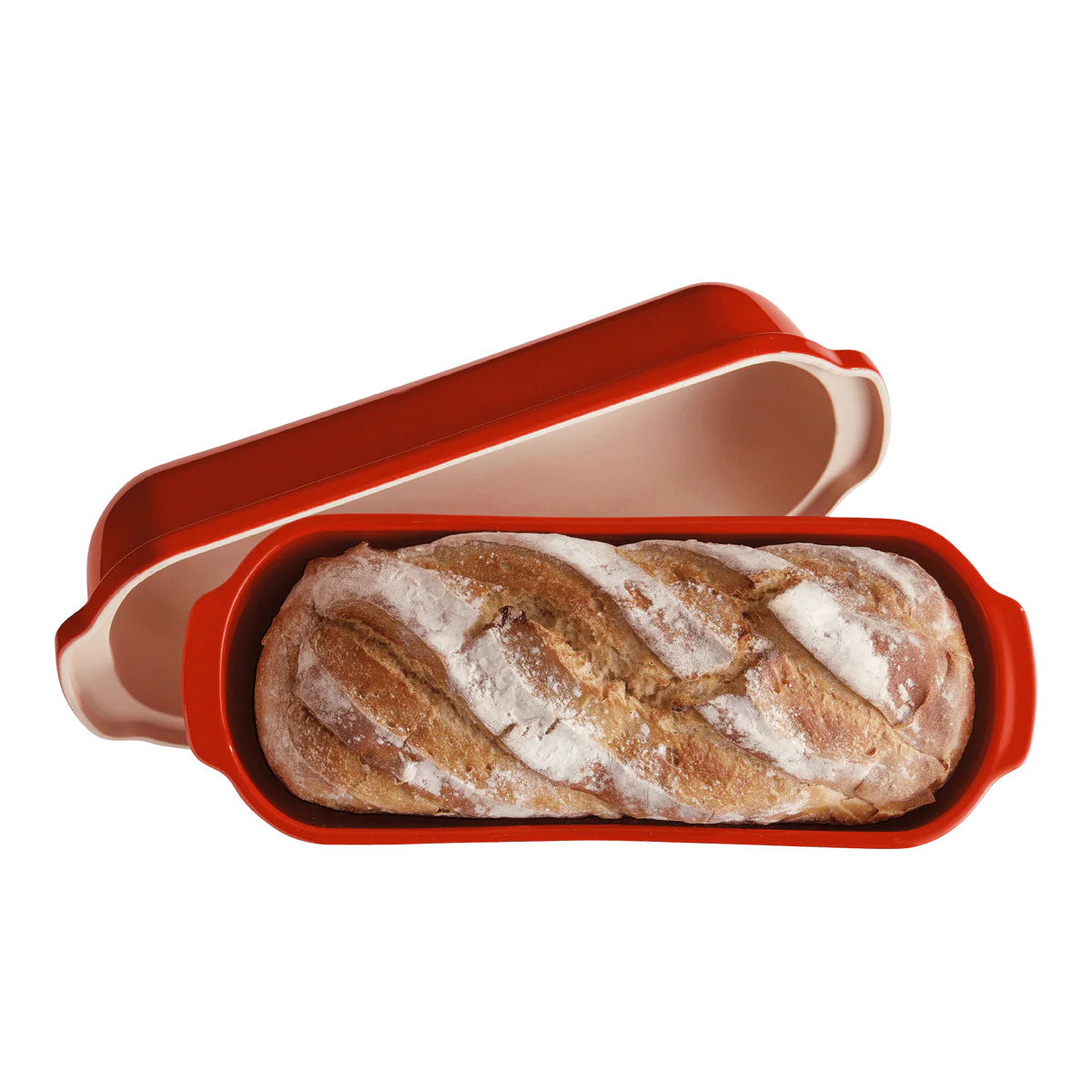 Loaf of bread in a red loaf pan on a white background