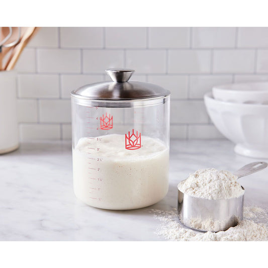 Glass container with flour on a kitchen counter