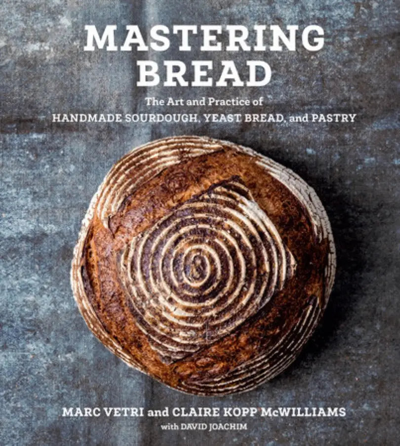 Book cover of 'Mastering Bread' with a loaf of bread on a textured background