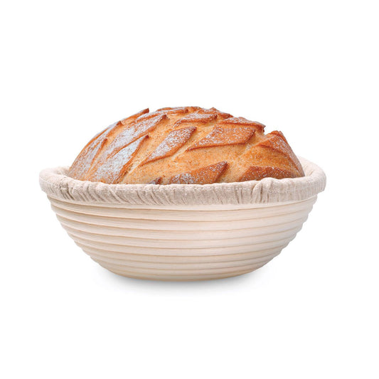 Loaf of bread in a round bread basket on a white background