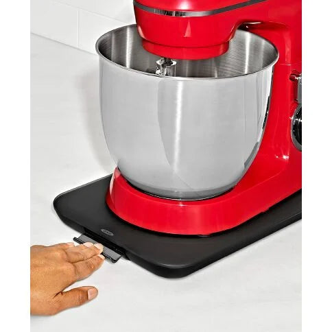 Red stand mixer with a black anti-slip mat on a white surface