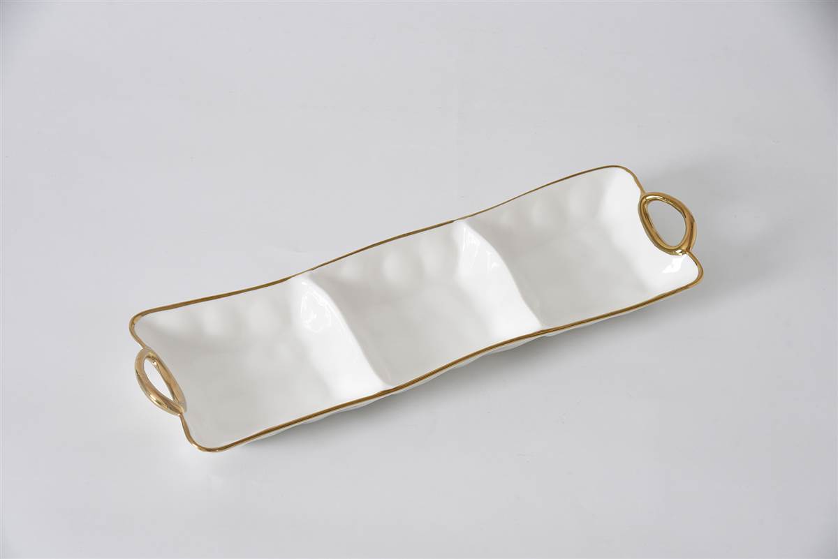 Rectangular ceramic tray with gold rim and handles on a light gray background