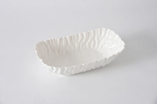 White ceramic bowl with textured surface on a light gray background