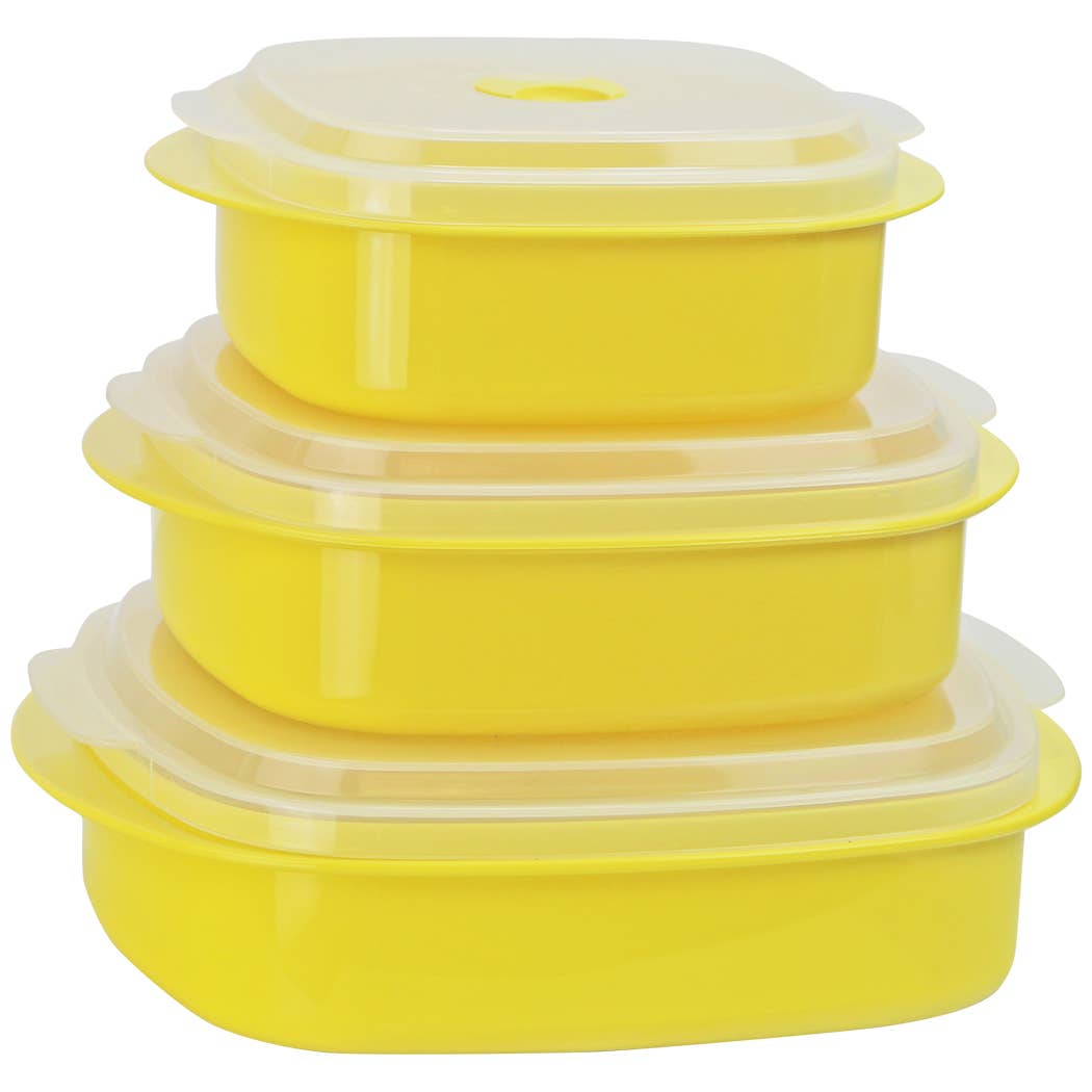 Set of yellow silicone containers with lids on a white background
