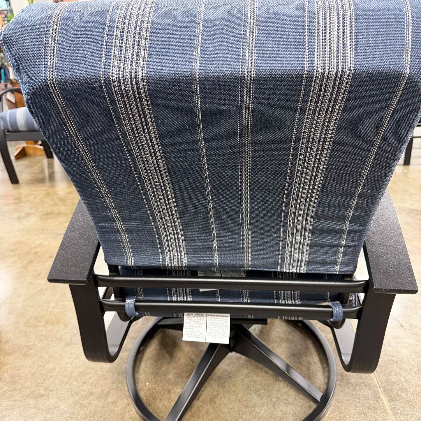 Chair with striped blue and gray cushion on a beige floor