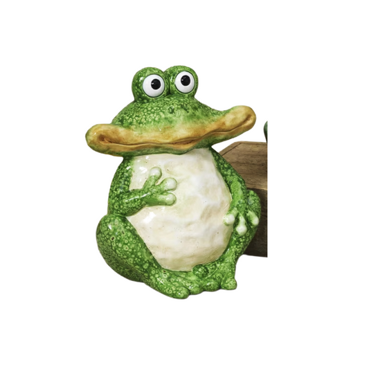 Green frog figurine with a white belly on a white background