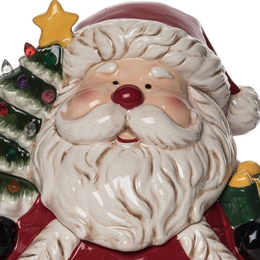 Decorative ceramic Santa Claus figure with a star on his head, surrounded by Christmas tree and gift elements.