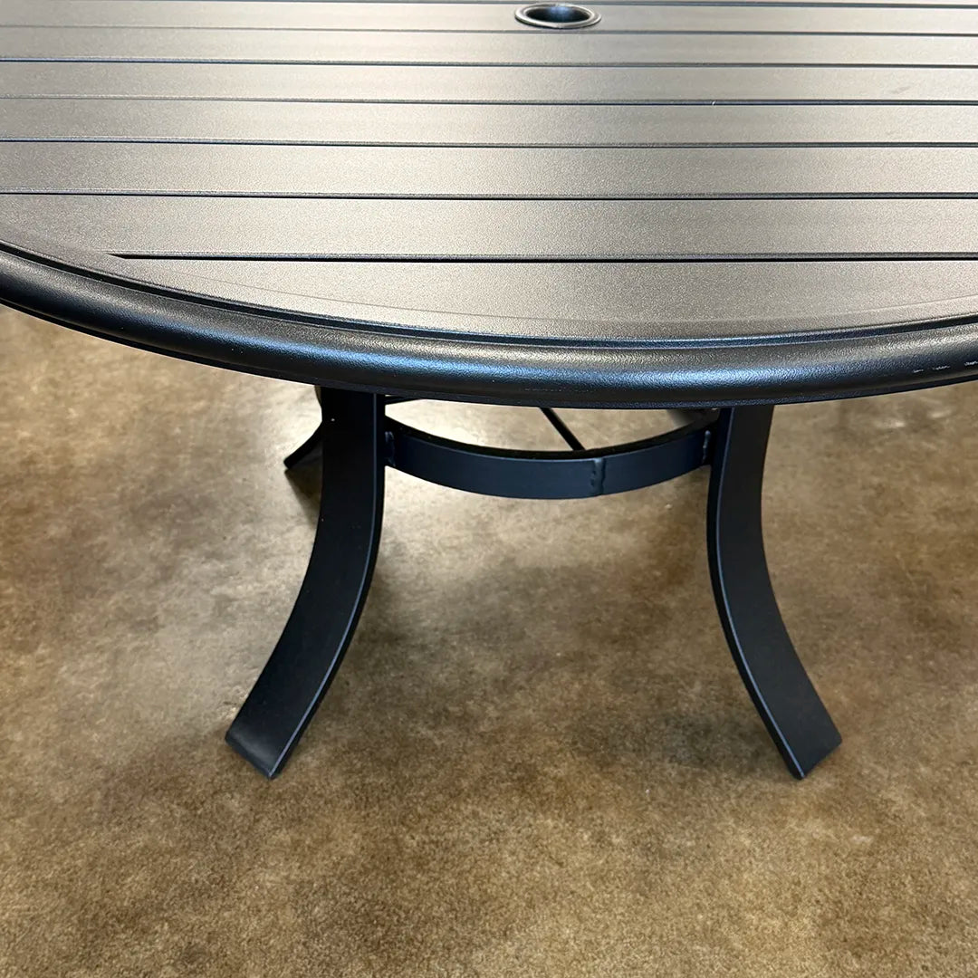 Round metal table on a concrete floor