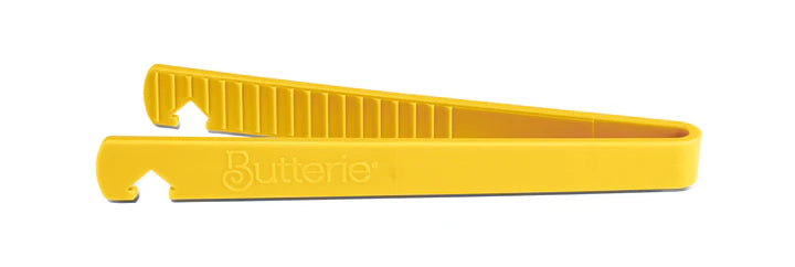 Yellow toaster tong on a white background