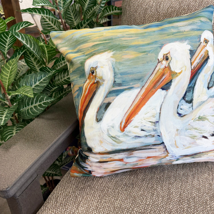 Throw pillow with pelican print on edge of sofa