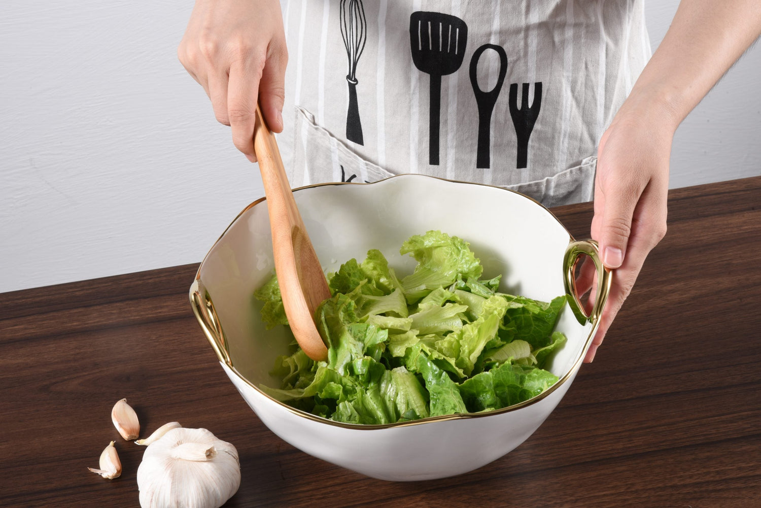 Woman mixing salad in a Pampa Bay bowl