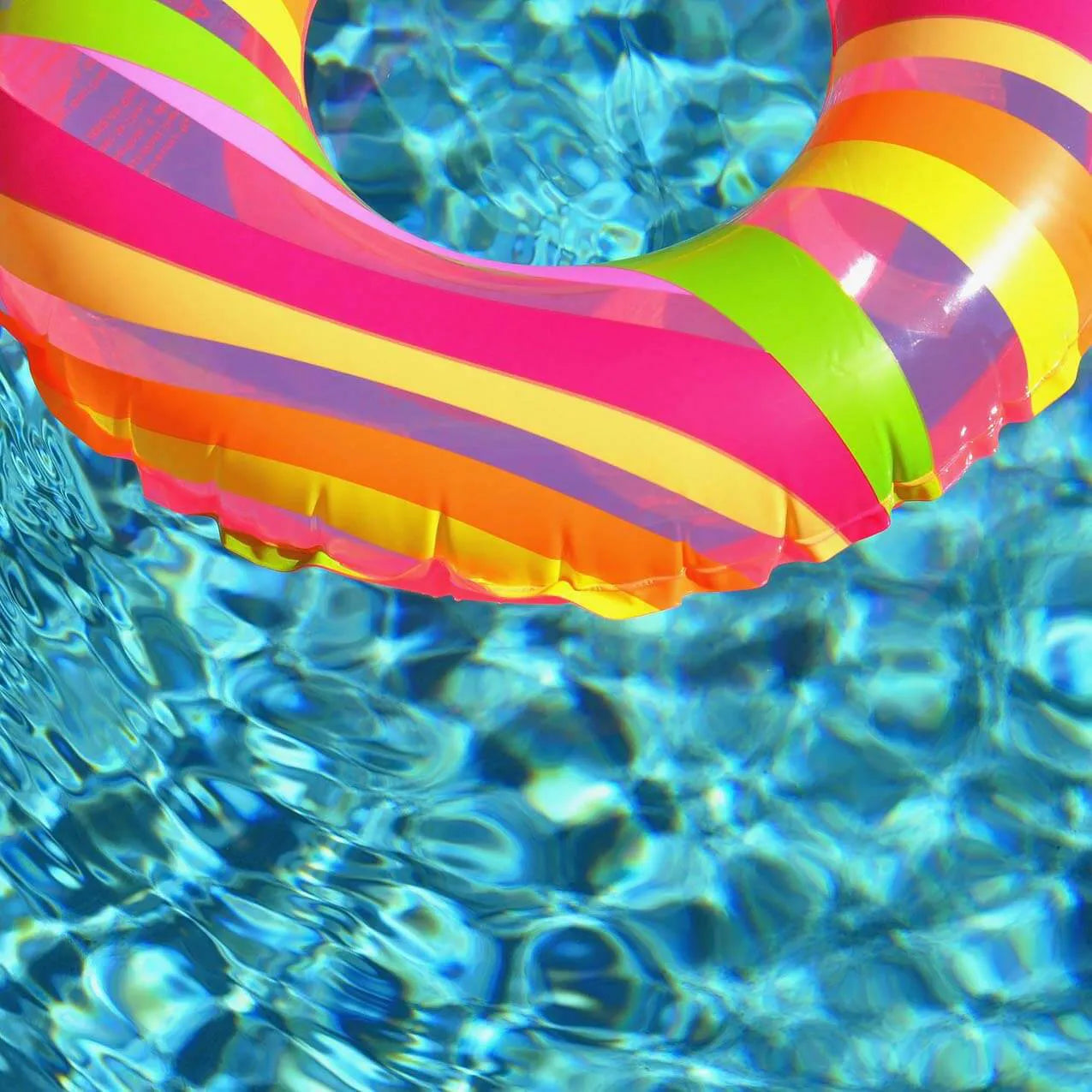 Striped swimming pool float on water