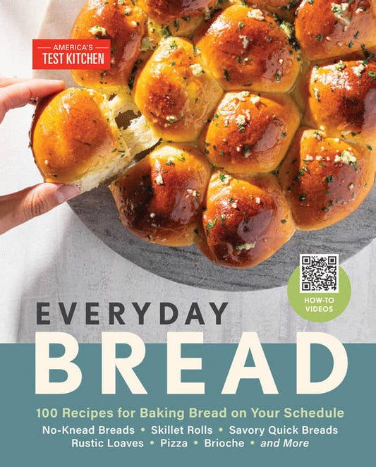 Book cover of 'Everyday Bread' with bread rolls and a hand holding one, featuring America's Test Kitchen.