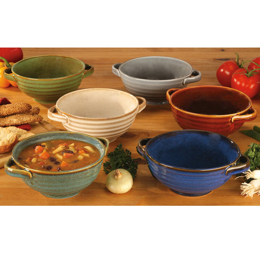 Set of colorful ceramic bowls on a wooden table with food and vegetables.