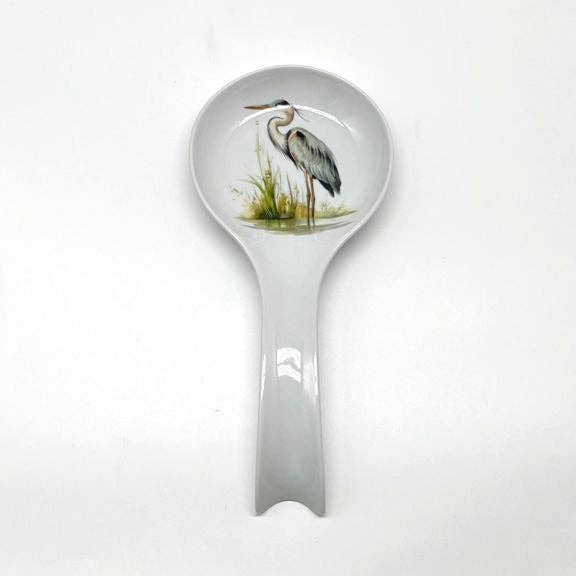 Spoonrest with a heron design on the bowl against a white background