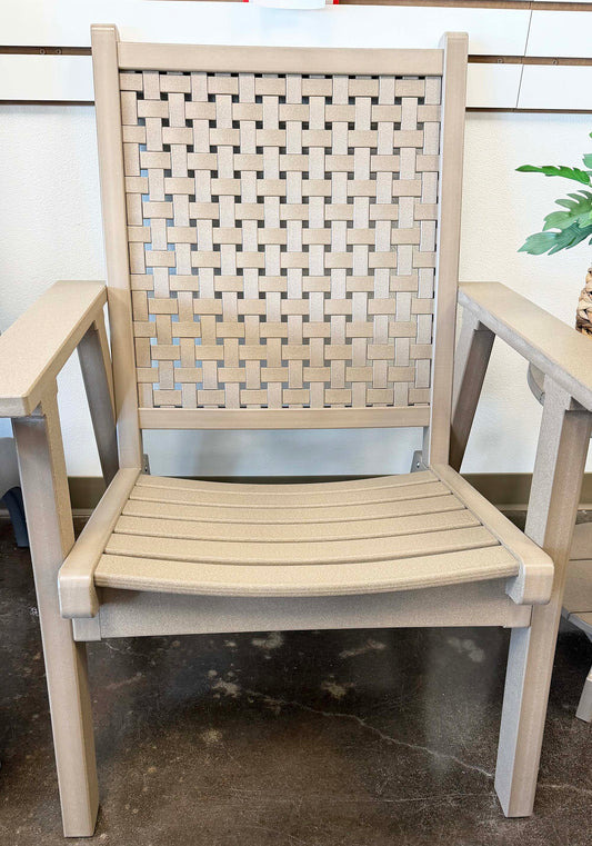 Beige recycled plastic chair with woven backrest on a concrete floor.