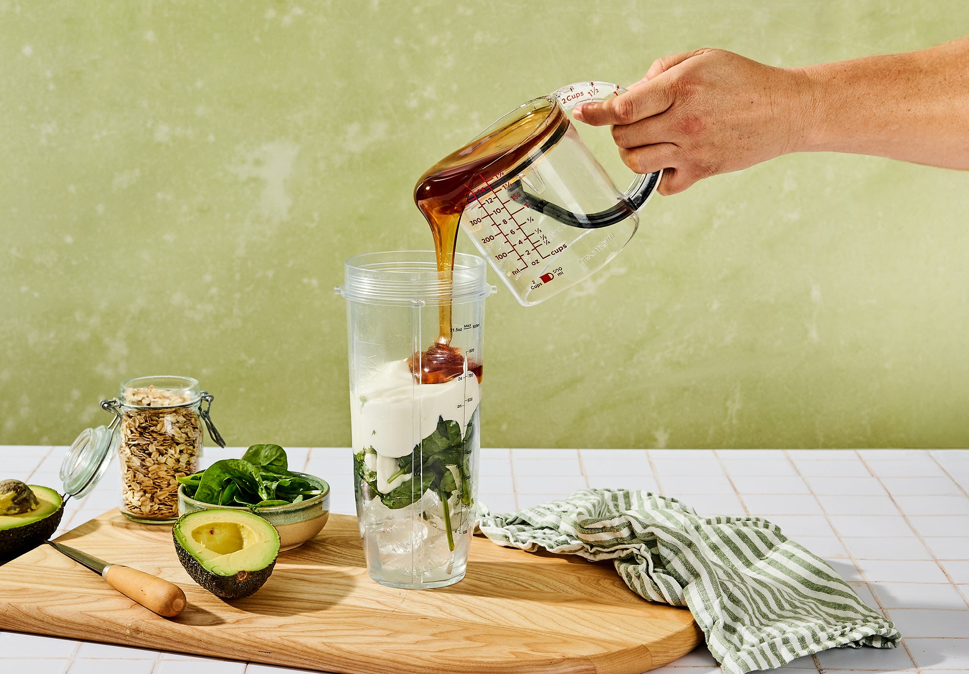 Dreamfarm Upcup pouring syrup into a blender jar