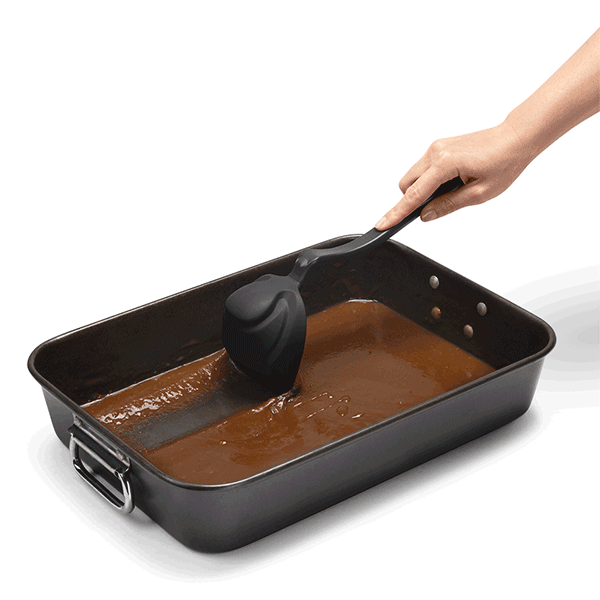 Dreamfarm Fladle in black being used to scrape a pan of gravy
