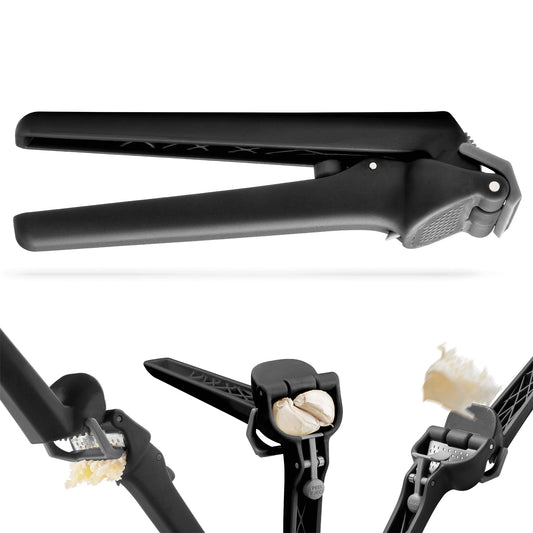 Black garlic press with garlic cloves on a white background