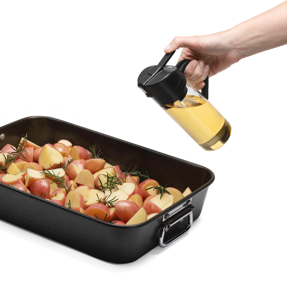 Using the Oileroo to spray a pan of potatoes