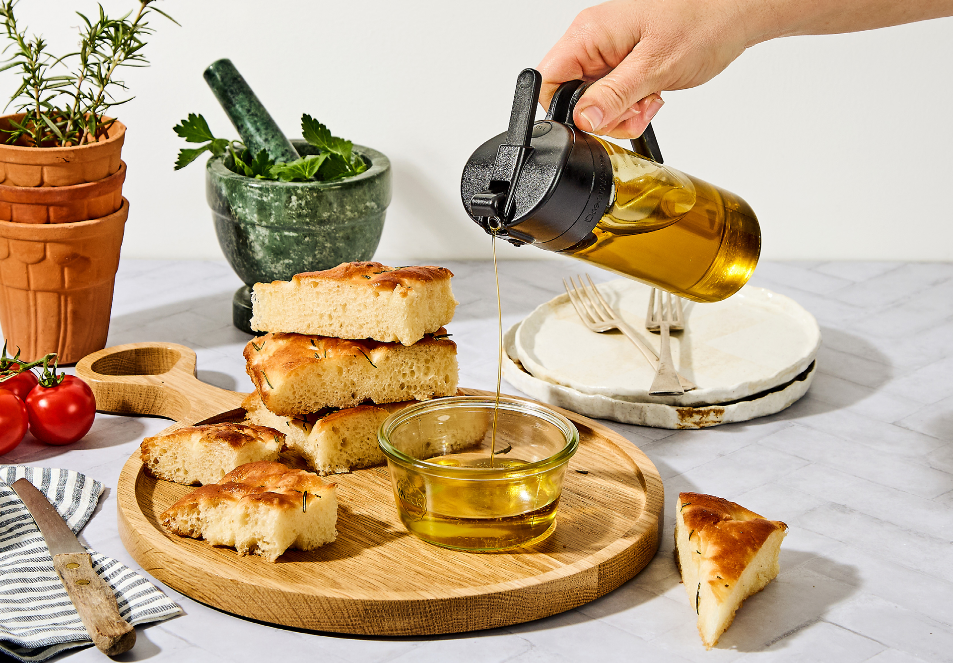 Oileroo being used to pour oil for bread