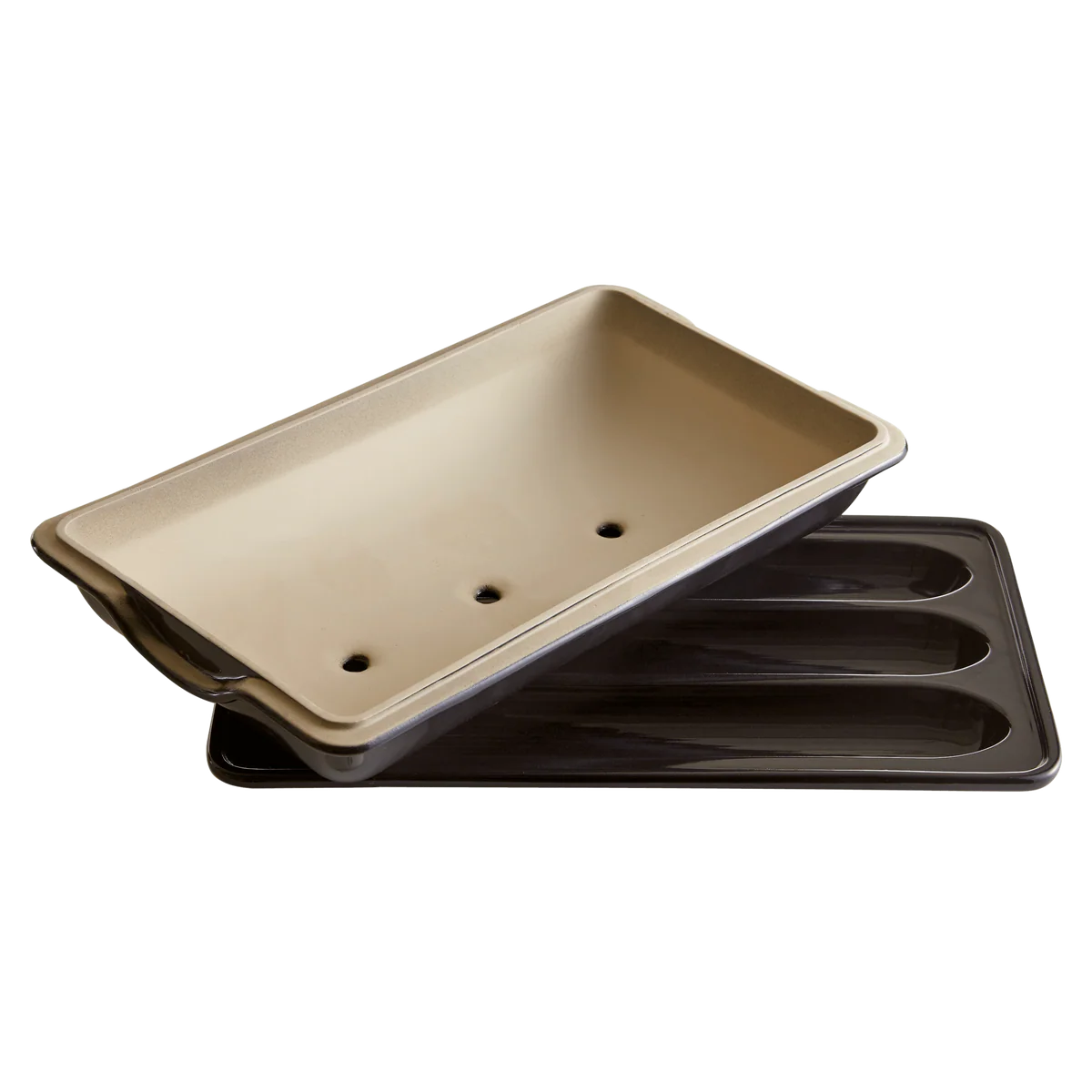 Two baking trays, one beige and one black, on a white background