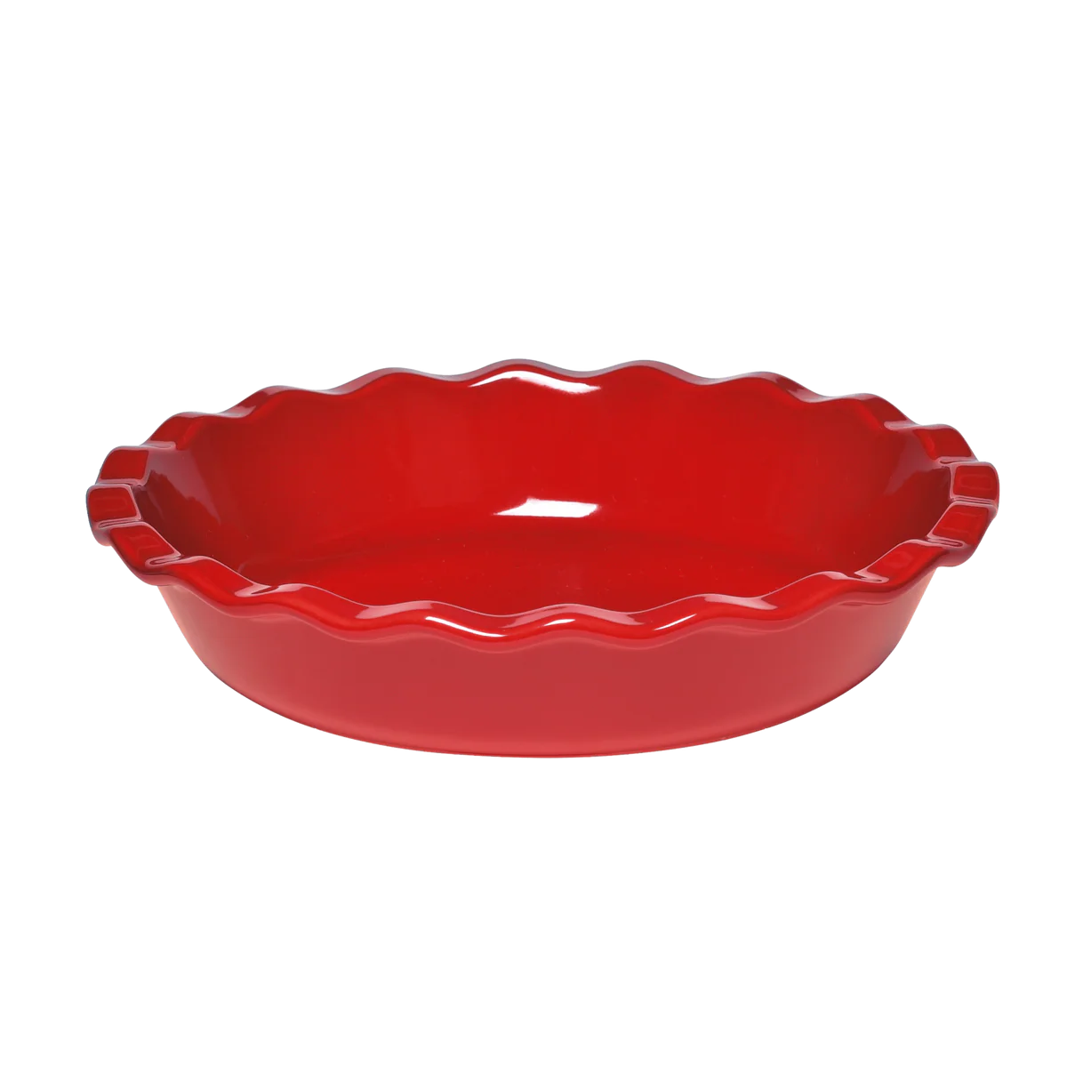 Red pie dish with scalloped edge on a white background