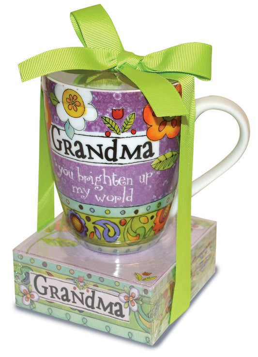Colorful mug with floral design and text 'Grandma you brighten up my world' in a decorative box with a green ribbon.