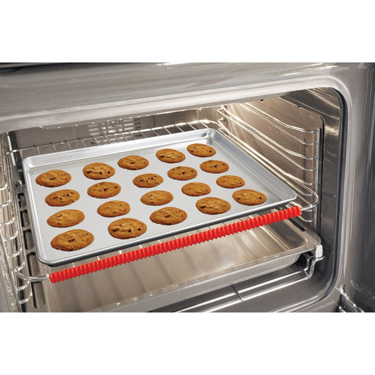 Oven with a tray of cookies baking inside with silicone oven rack shield 