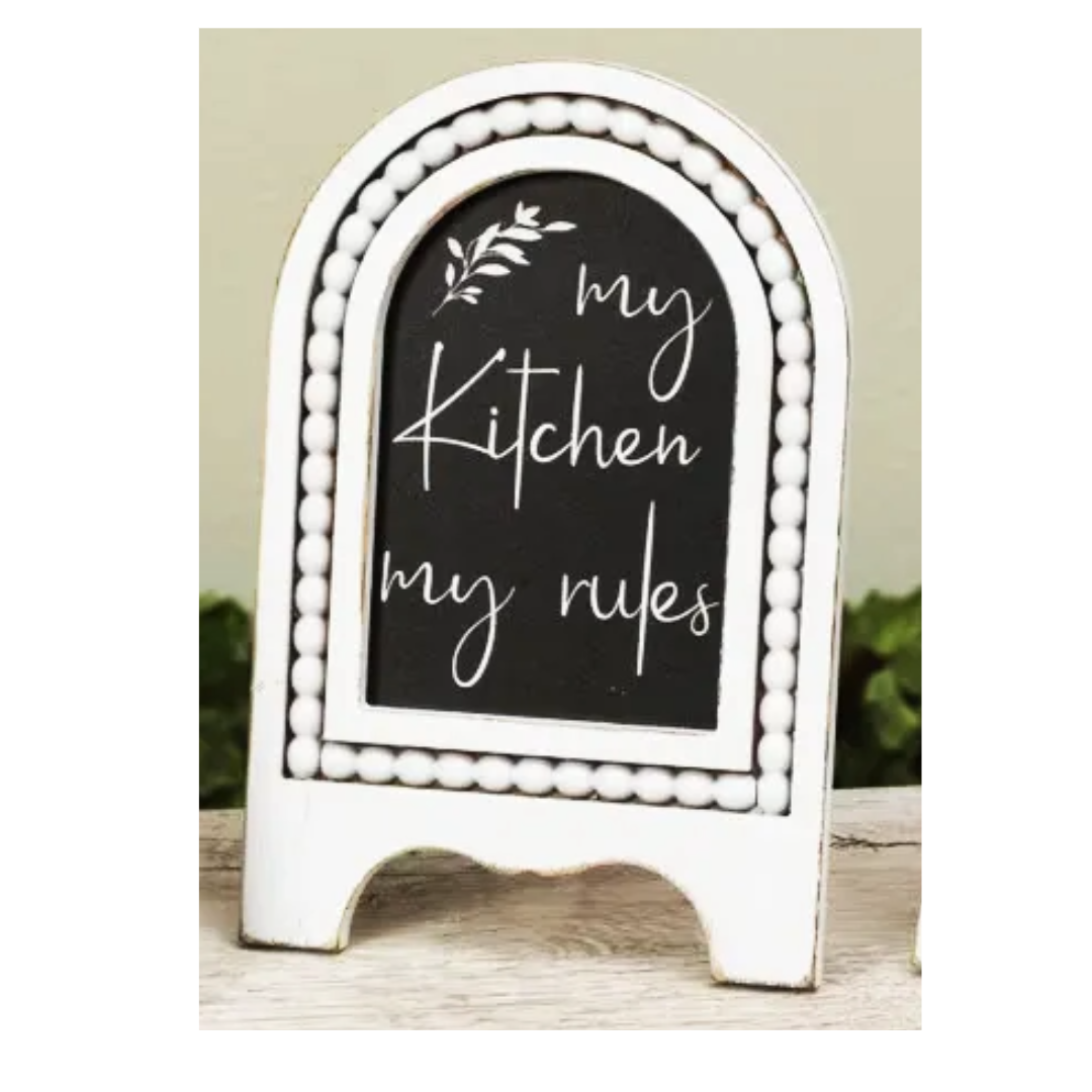 Decorative chalkboard sign with 'my Kitchen my rules' text on a white stand.