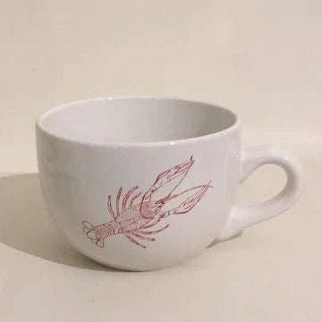White gumbo bowl with crawfish design on a beige background