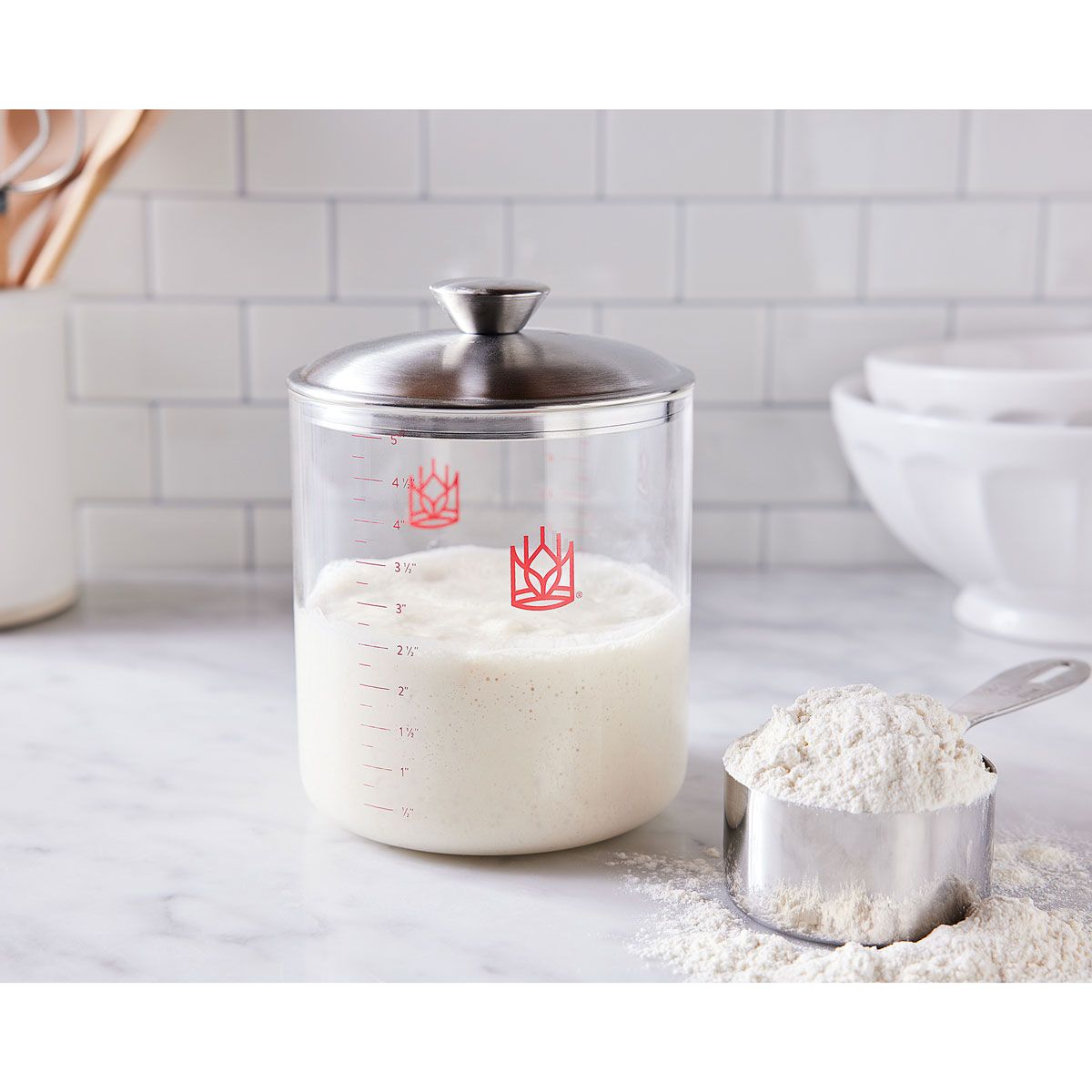 Glass container with flour on a kitchen counter