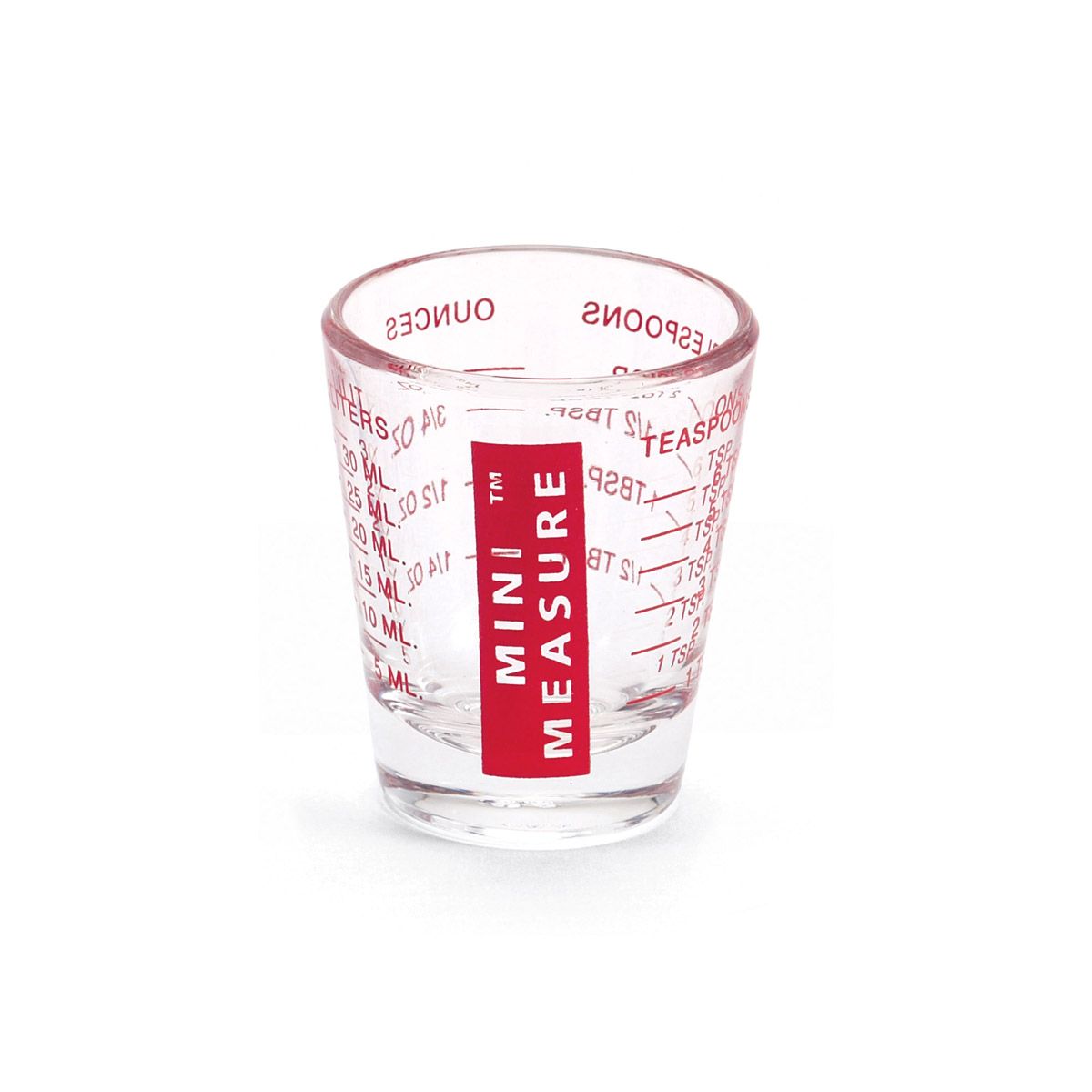 Clear glass measuring cup with red label on a white background