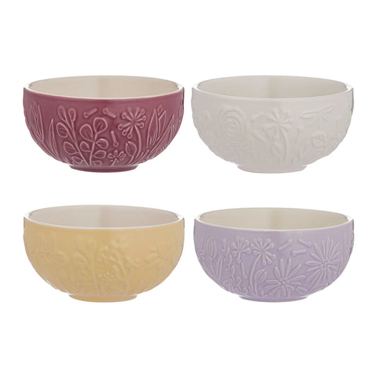 Set of four ceramic bowls in different pastel colors with floral patterns on a white background.