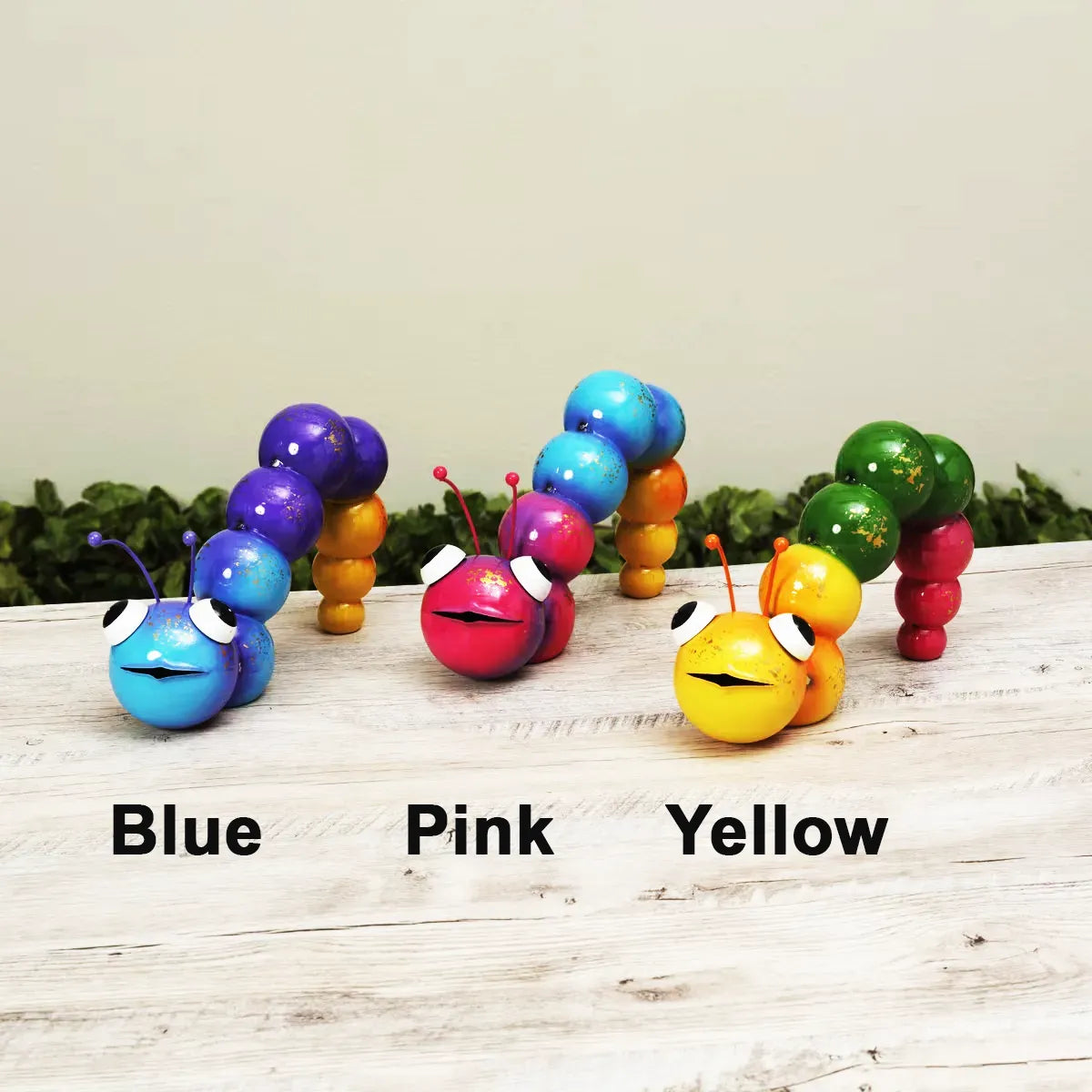Colorful caterpillars on a wooden surface with labeled colors.