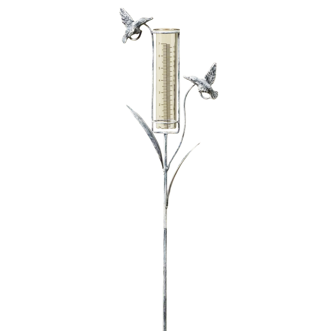 Decorative garden rain gauge stake with a glass container and hummingbird designs on a white background