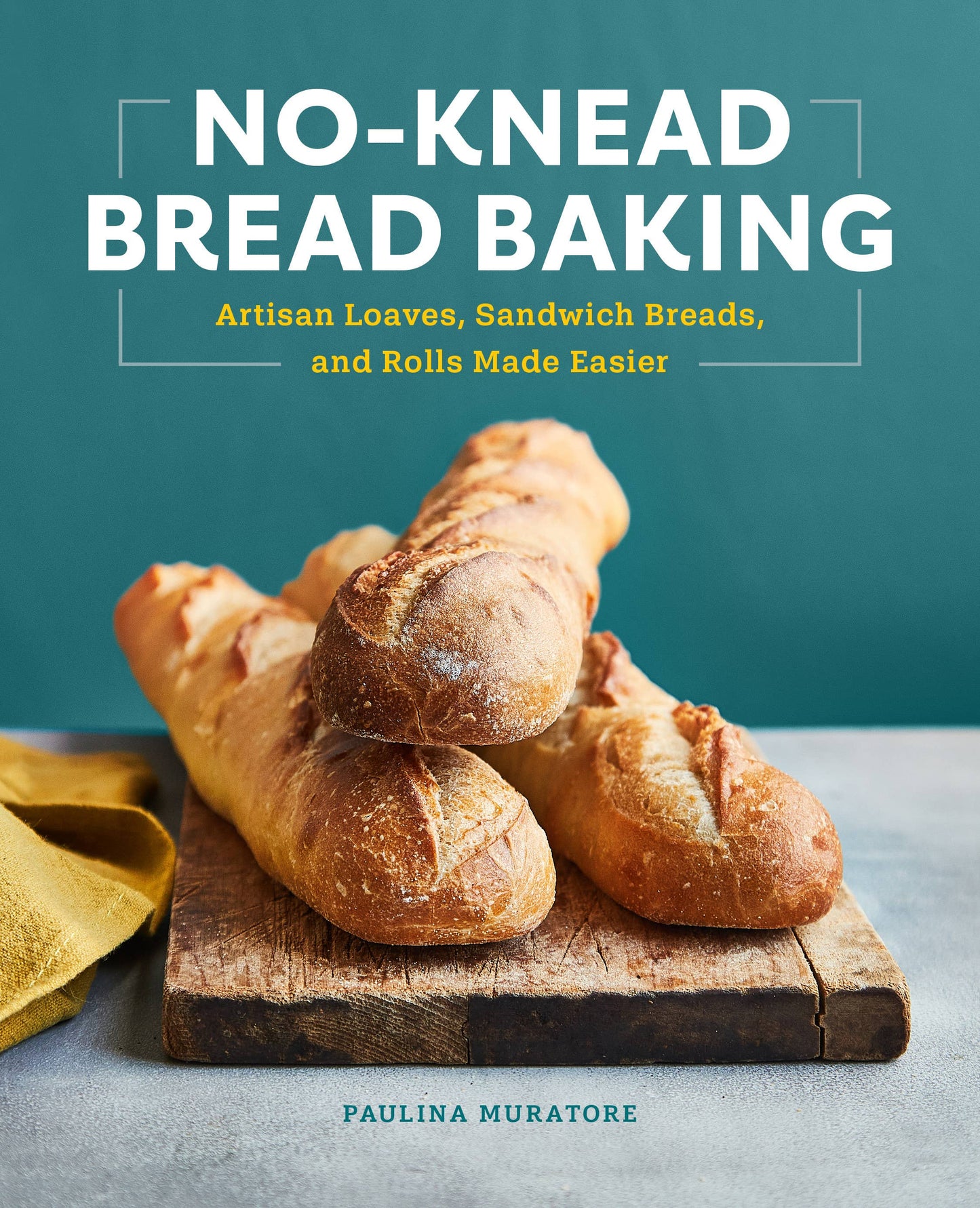 Book cover of 'No-Knead Bread Baking' with bread on a wooden board against a teal background.