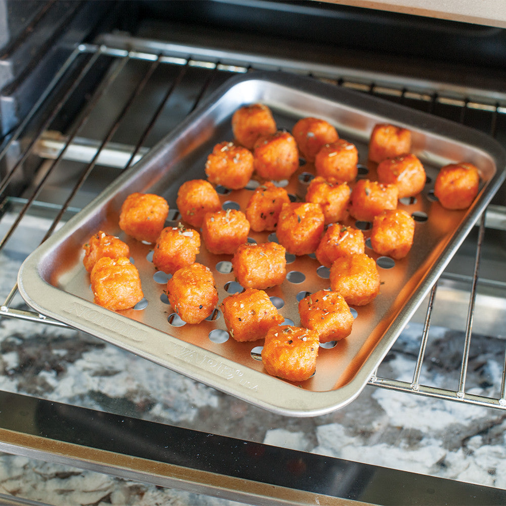 Tray of tater tots in an oven