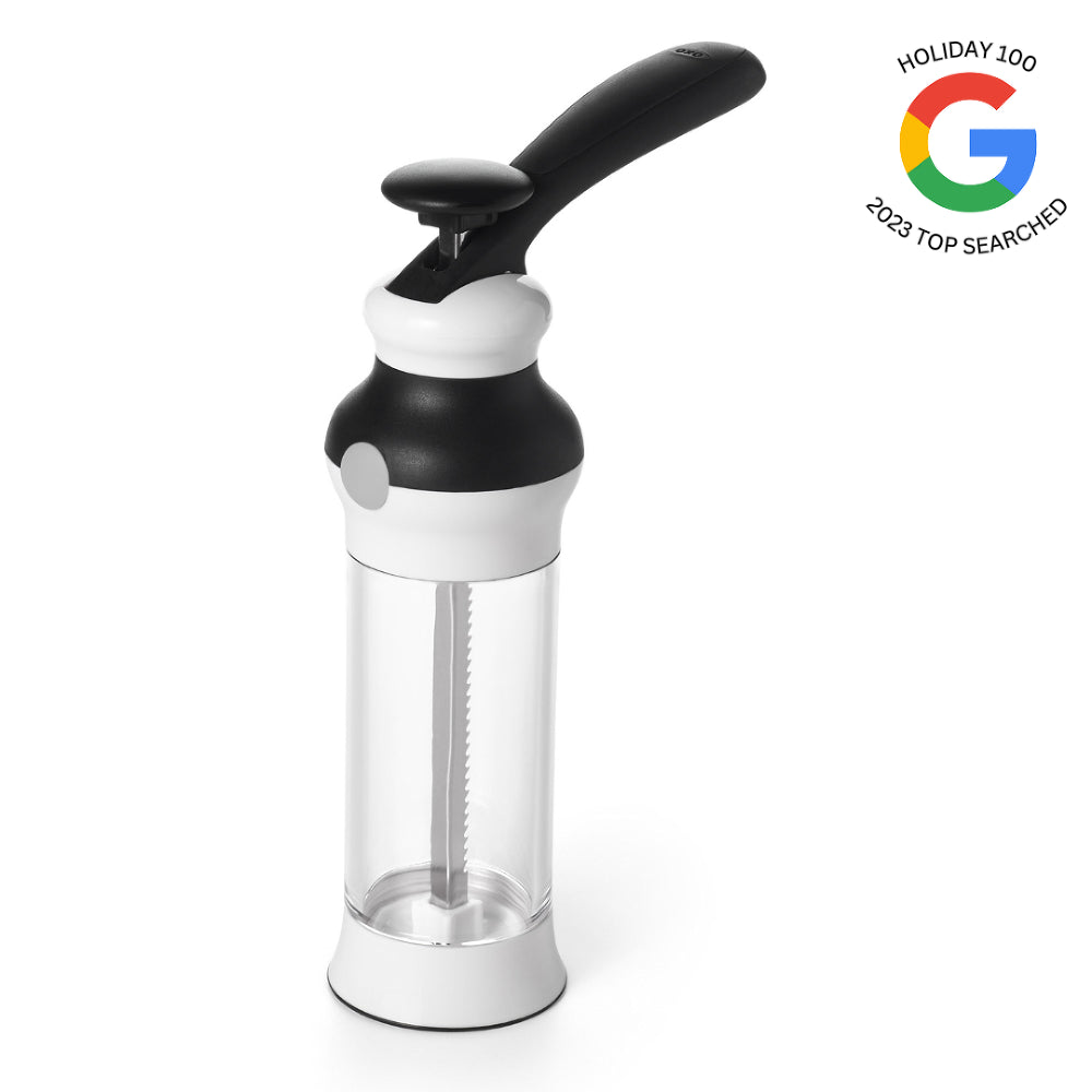 Black and white kitchen tool with a clear container on a white background, featuring Google's 'Holiday 100' logo.