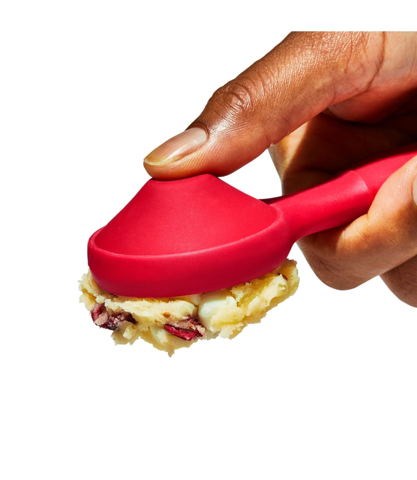 Hand using a red spoon to scoop food, with a white background